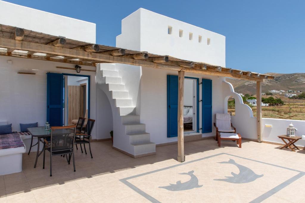 a villa with a balcony with a table and chairs at Oneiric Harmony in Mikri Vigla