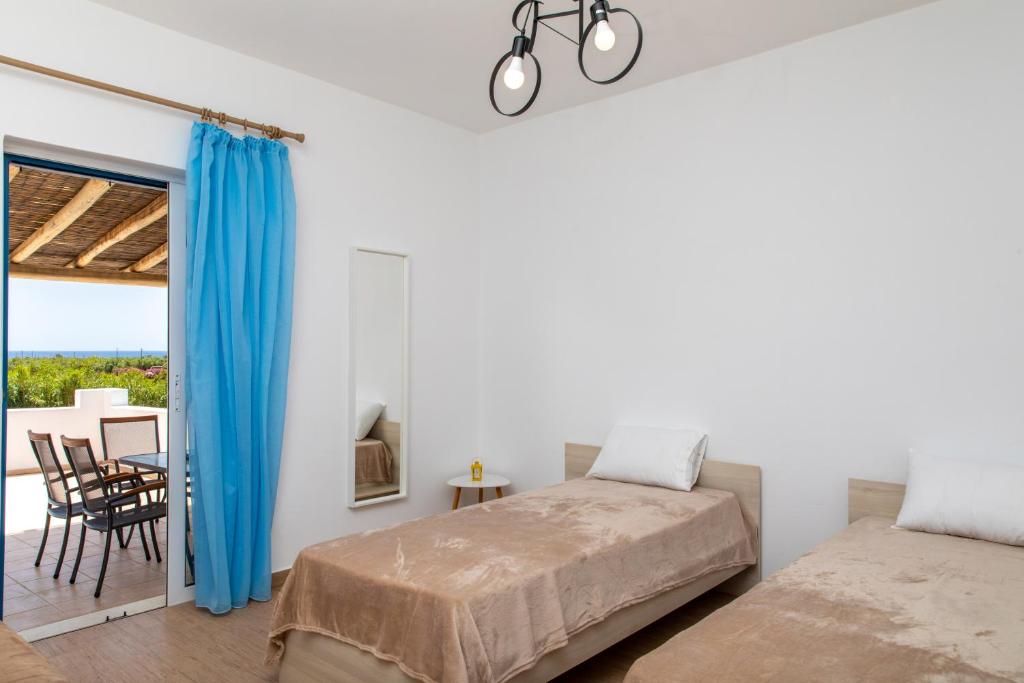 a bedroom with a bed and a dining room at Oneiric Harmony in Mikri Vigla