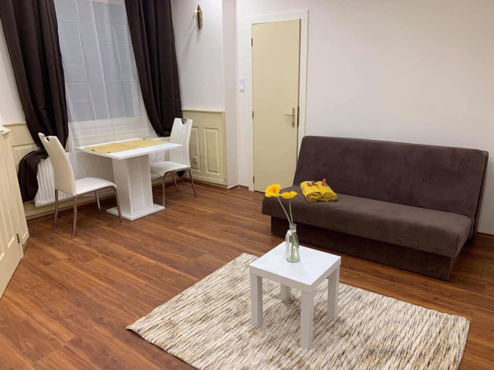 a living room with a couch and a table at Malasits Apartman in Győr