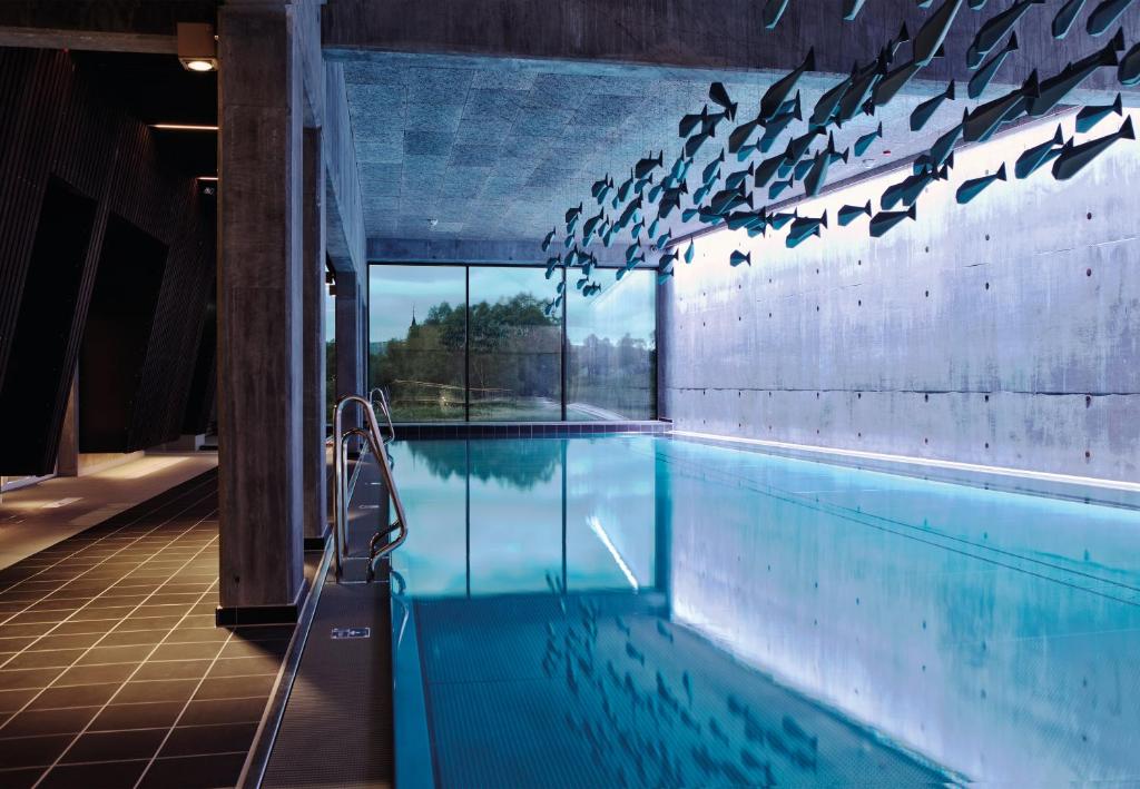 a swimming pool with a view of the water at Røros Hotell - Bad & Velvære in Røros