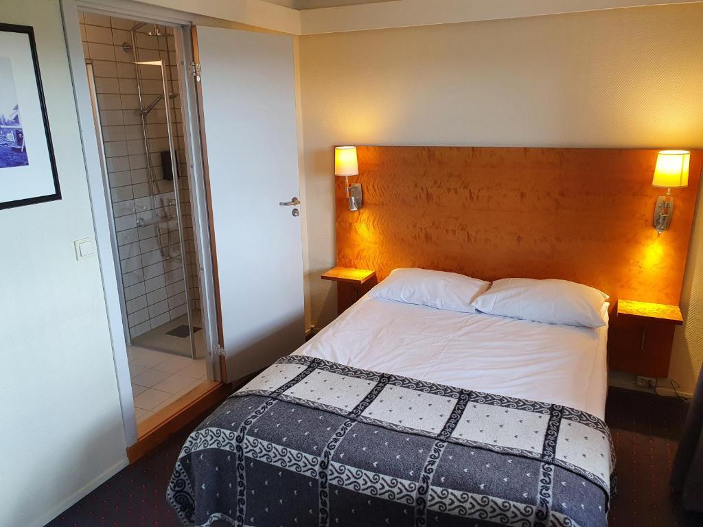 Postel nebo postele na pokoji v ubytování Røros Hotell - Bad & Velvære