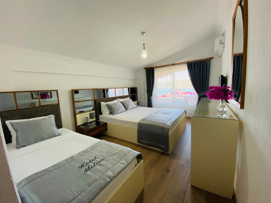 Postel nebo postele na pokoji v ubytování Melisa Hotel