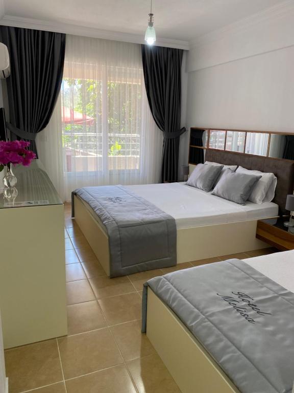 Postel nebo postele na pokoji v ubytování Melisa Hotel