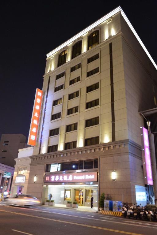a building on a city street at night at Fuward Hotel Tainan in Tainan