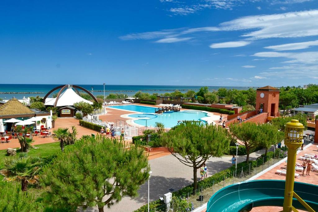 a view of a resort with a swimming pool at Casa Mobile - Spiaggia e Mare Holiday Park in Porto Garibaldi