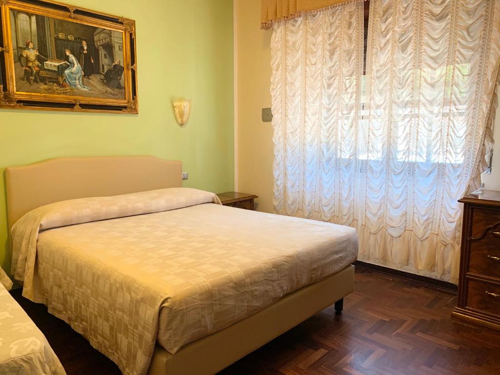 Postel nebo postele na pokoji v ubytování Hotel Villaggio Ristorante Pizzeria Museo TANIT