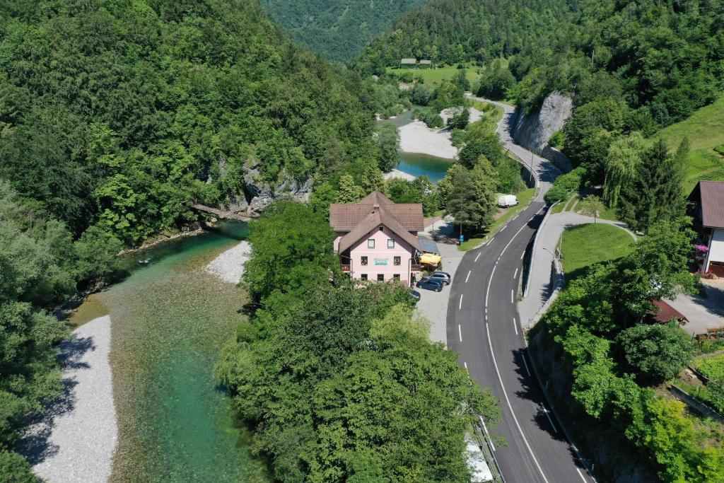 an aerial view of a house next to a river at Okrepčevalnica Kurn'k in Cerkno