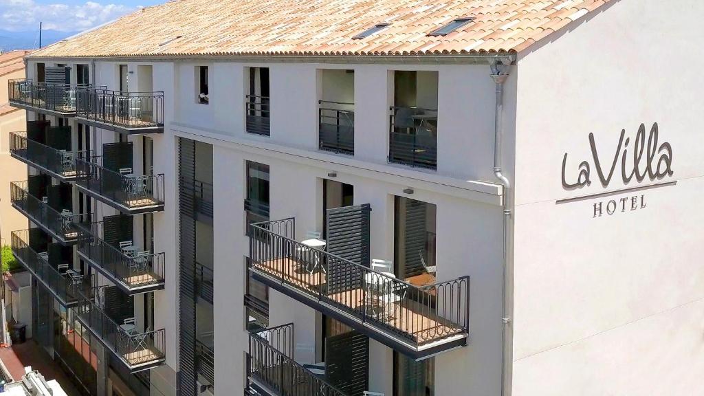 a white building with balconies and a hotel at Hôtel La Villa Port d'Antibes & Spa in Antibes