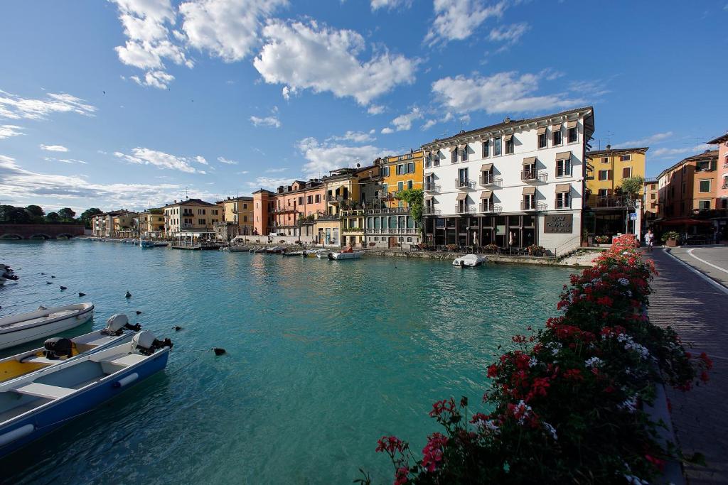 a view of a river with boats in the water at Hotel Bell'arrivo by Dori in Peschiera del Garda