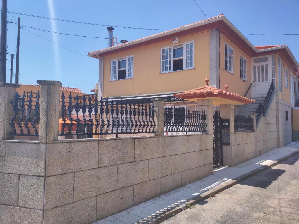 a house with a fence and an umbrella at CASA PARDAIÑA in Vigo