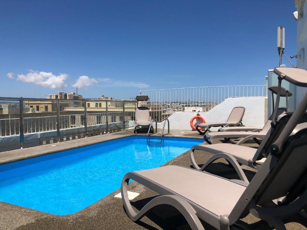 a swimming pool on the roof of a building at Osborne Hotel in Valletta