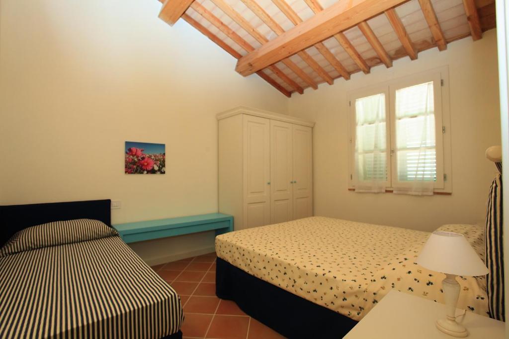 Postel nebo postele na pokoji v ubytování Agriturismo Campallegro