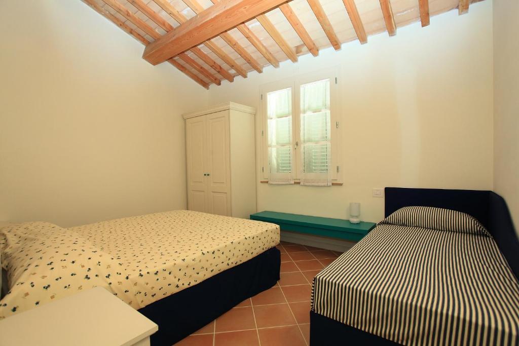 Postel nebo postele na pokoji v ubytování Agriturismo Campallegro