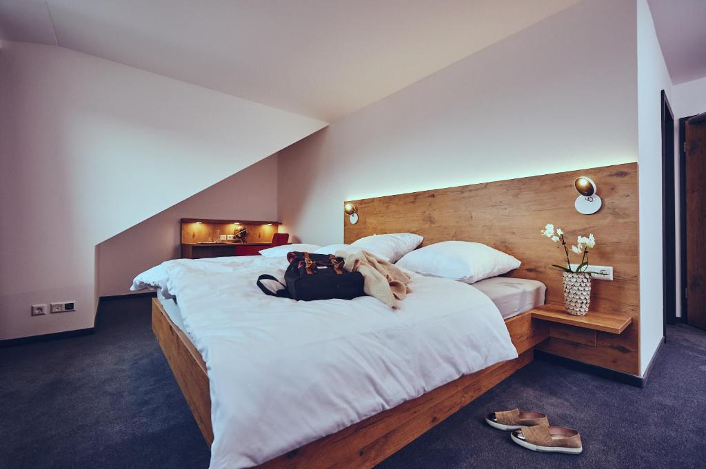 a woman laying on a bed in a bedroom at Die Burg in Donaueschingen