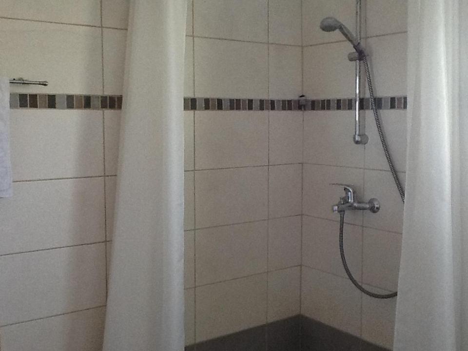 a shower with a shower curtain in a bathroom at Olimpus Garden Homes in Ayia Napa