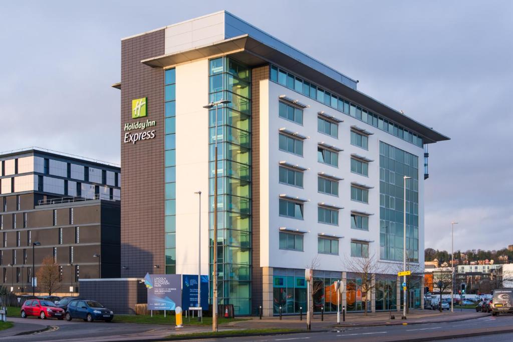 a building with a sign on the side of a street at Holiday Inn Express Lincoln City Centre, an IHG Hotel in Lincoln