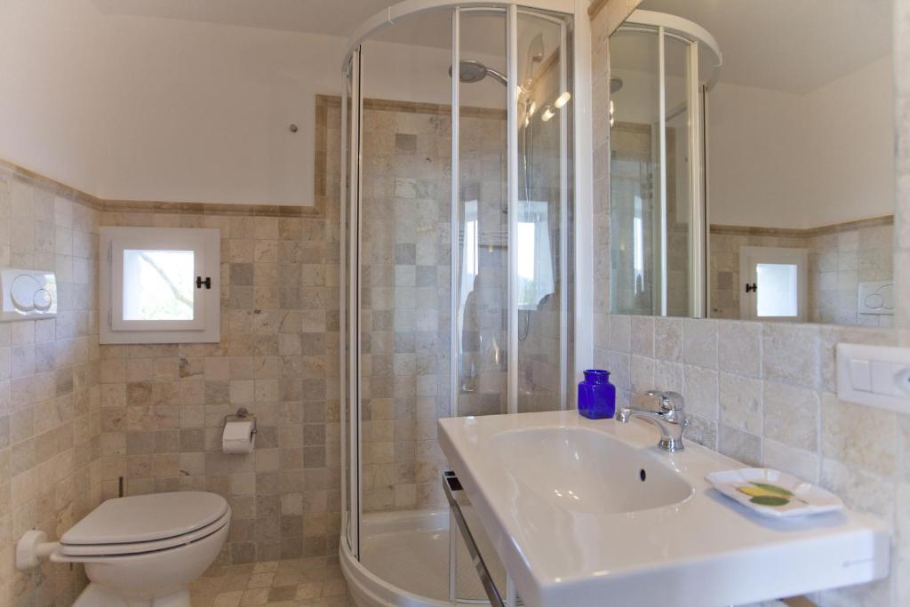 a bathroom with a toilet and a sink and a shower at Villa Stella in Massa Lubrense
