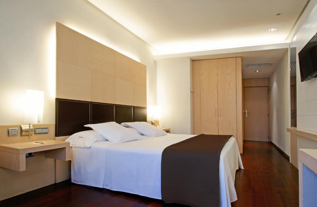 Postel nebo postele na pokoji v ubytování Hotel Mozart