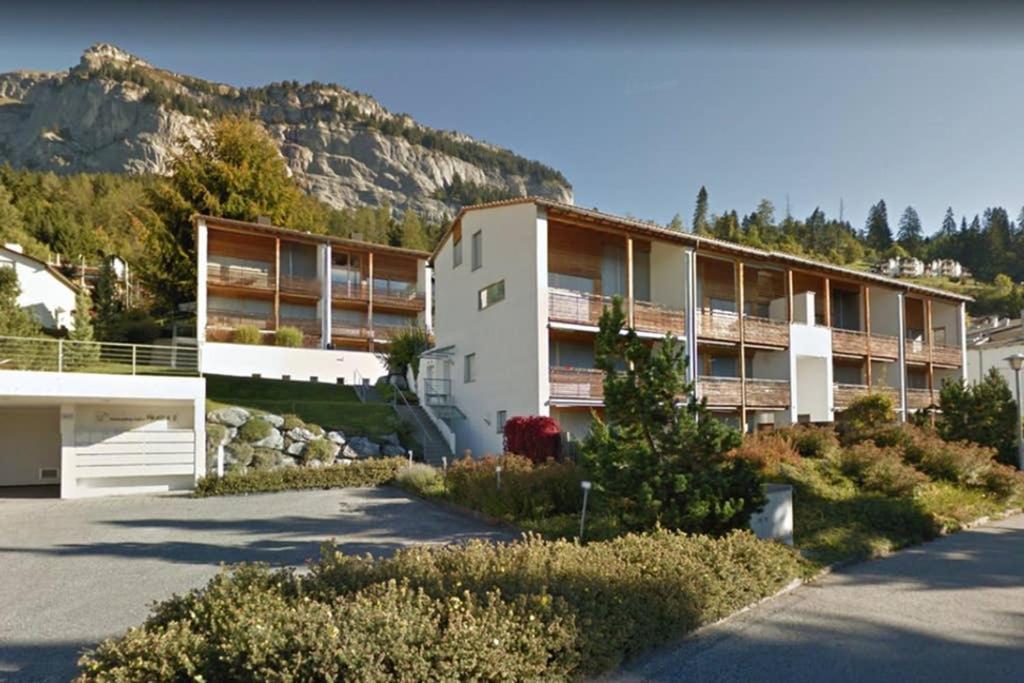 an apartment building with a mountain in the background at Prada 2 in Flims