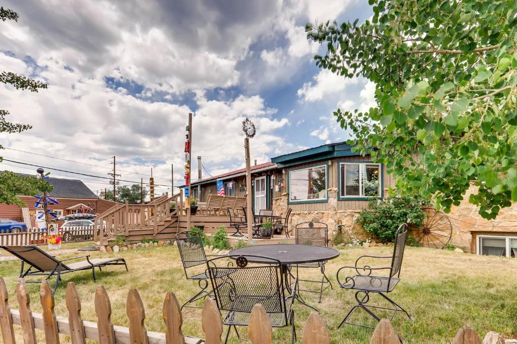 a house with a table and chairs in the yard at Inn the Clouds Hostel & Inn in Leadville