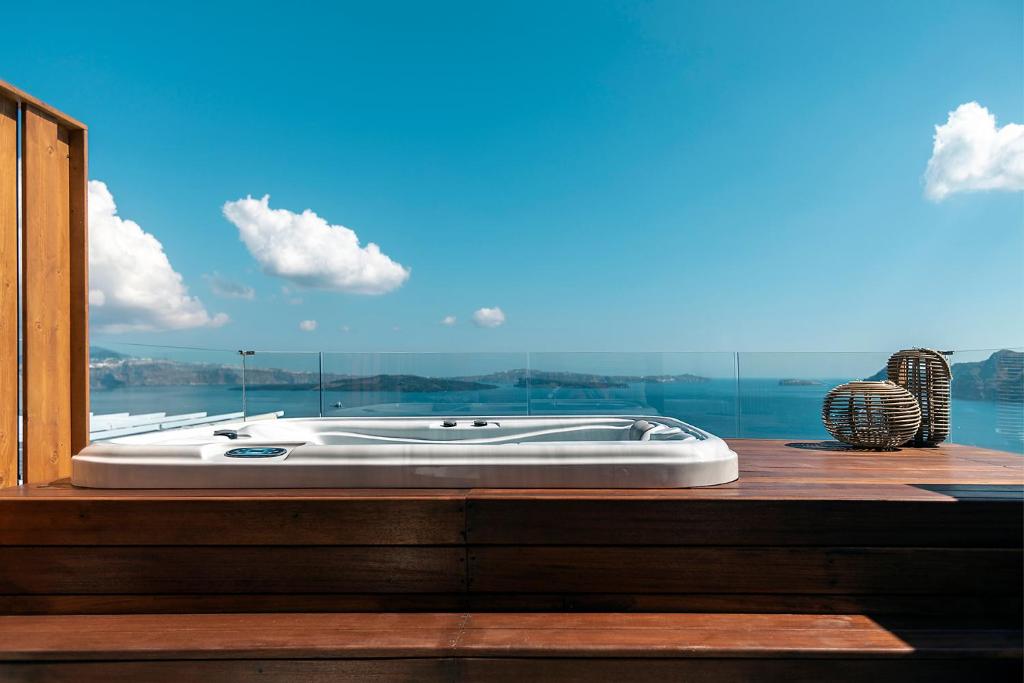 a bath tub sitting in front of a window at 3 Elements by Stylish Stays in Oia