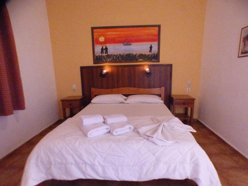 a bedroom with a bed with two towels on it at Eleni Apartments in Hersonissos
