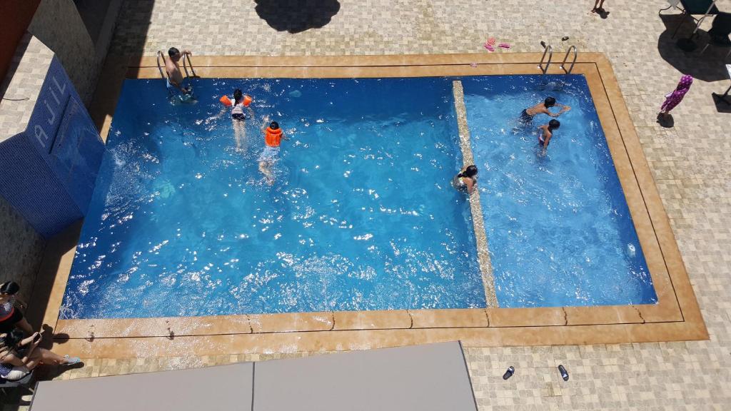 an overhead view of people in a swimming pool at Hôtel Ajil Cascades D'ouzoud in Ouzoud