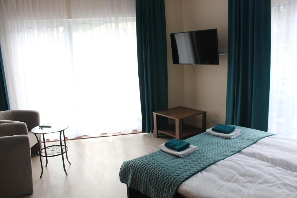Posteľ alebo postele v izbe v ubytovaní Apartamenty Jagiellońska 23
