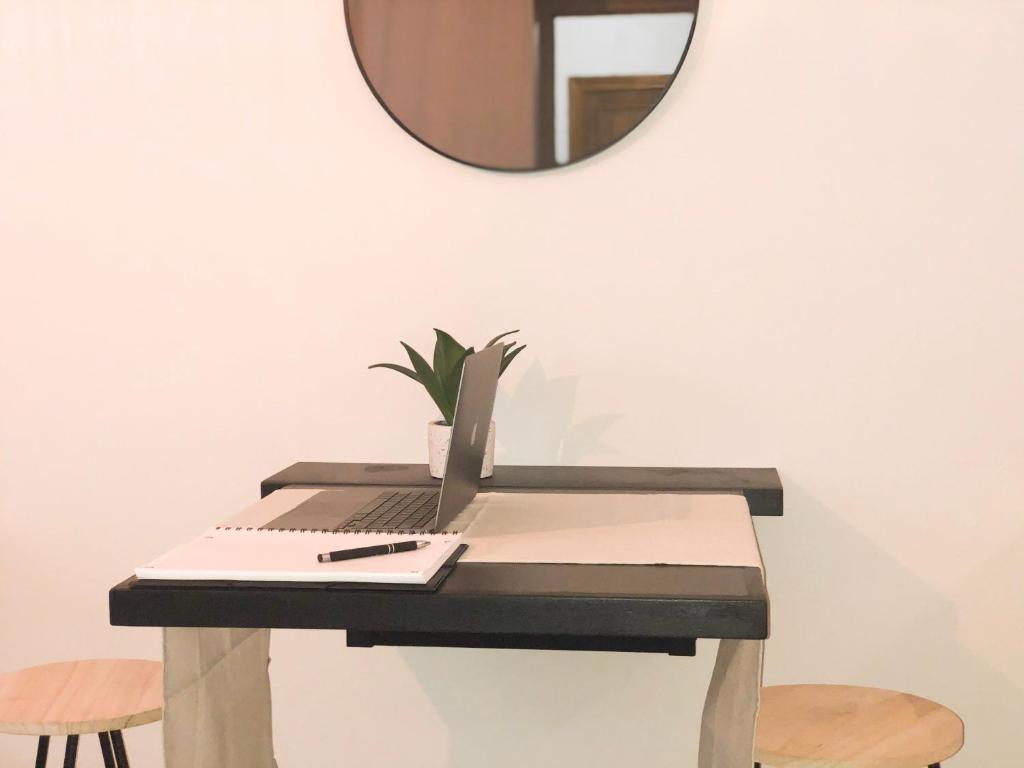 a desk with a mirror and a laptop on it at Studio Vieil Antibes - Saint Antoine in Antibes