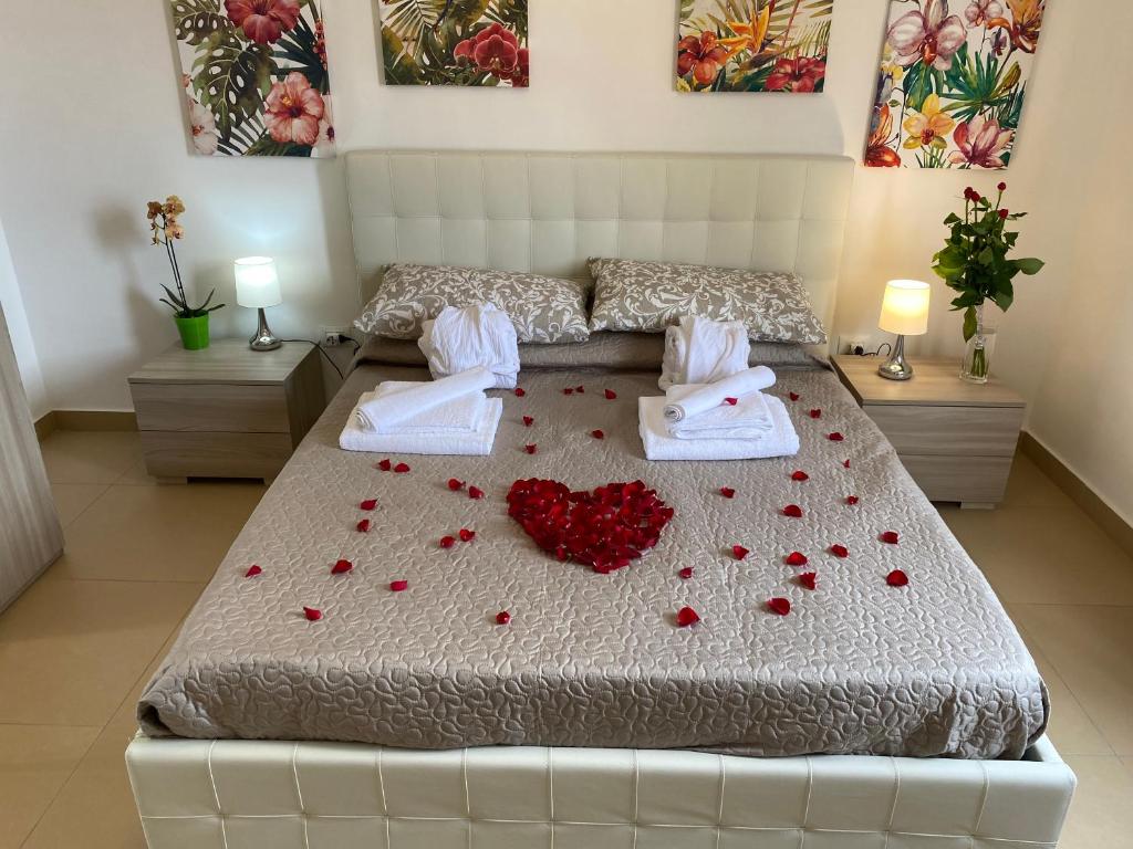 a bedroom with a bed with red hearts on it at Caserta Royale Apartment in Caserta