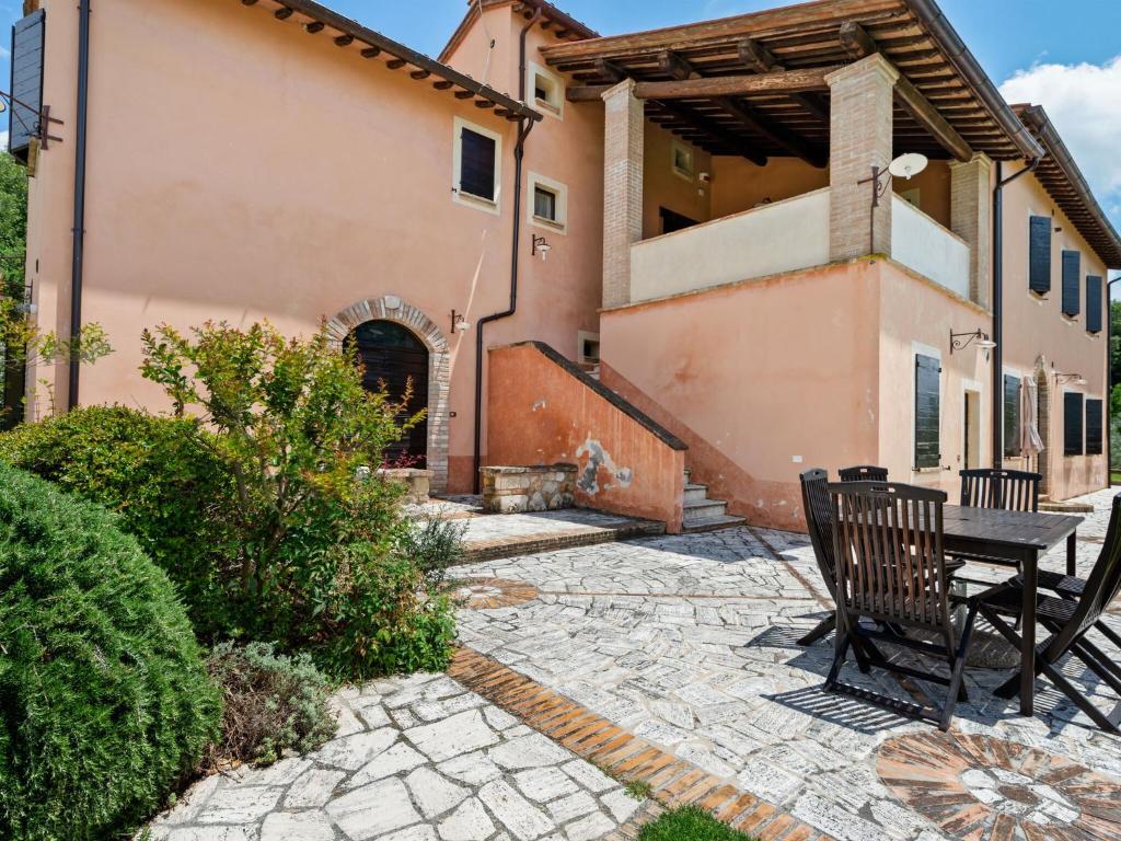 a bench sitting on a patio in front of a house at Farmhouse in Montoro near Montoro Castle in Narni