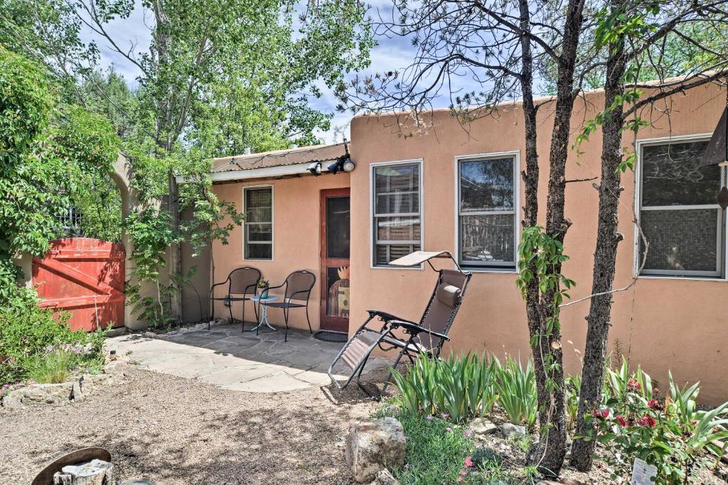 a house with a patio and chairs in a yard at Charming Casita Studio - Near Santa Fe Plaza! in Santa Fe