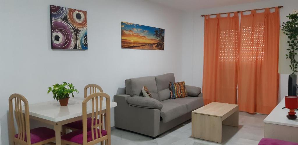 a living room with a couch and a table at Apartamento Junto a El Corte Inglés Algeciras 2 in Algeciras