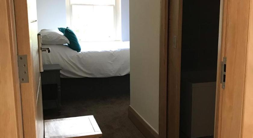 Postel nebo postele na pokoji v ubytování Oakham Hotel