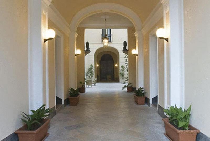 un pasillo de un hotel con macetas en Palazzo Serraino, en Trapani