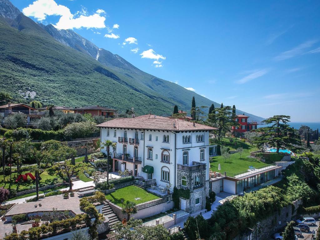 an aerial view of a house with mountains in the background at Bellevue San Lorenzo (Adults Only) in Malcesine