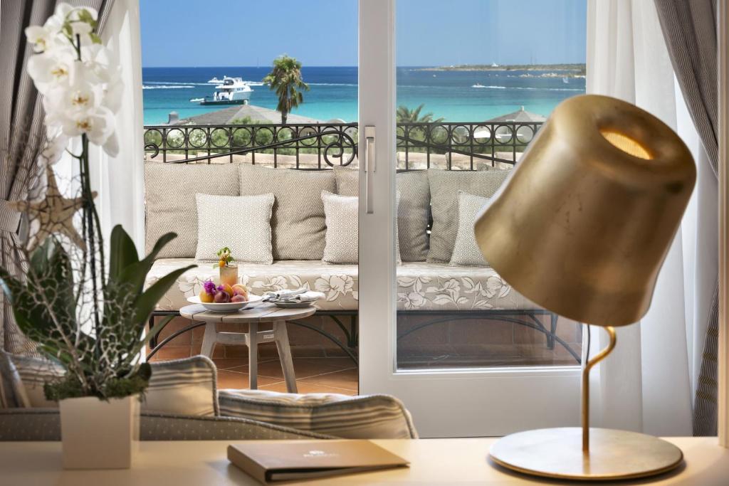 a living room with a view of the ocean at Hotel Abi d'Oru in Porto Rotondo