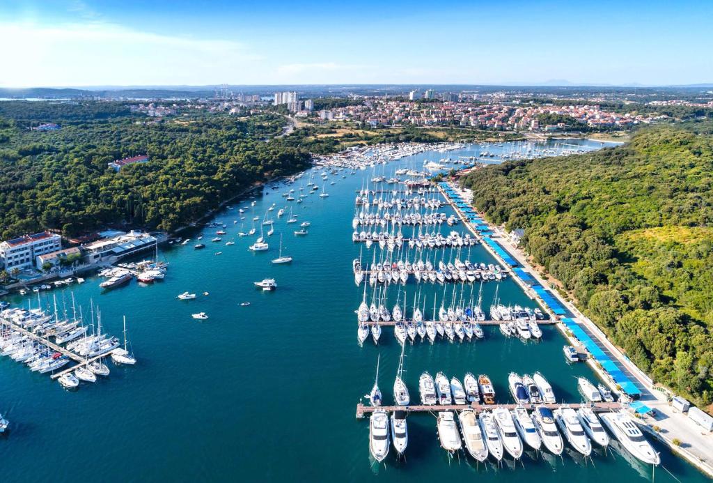 an aerial view of a harbor filled with boats at Ribarska Koliba Resort in Pula