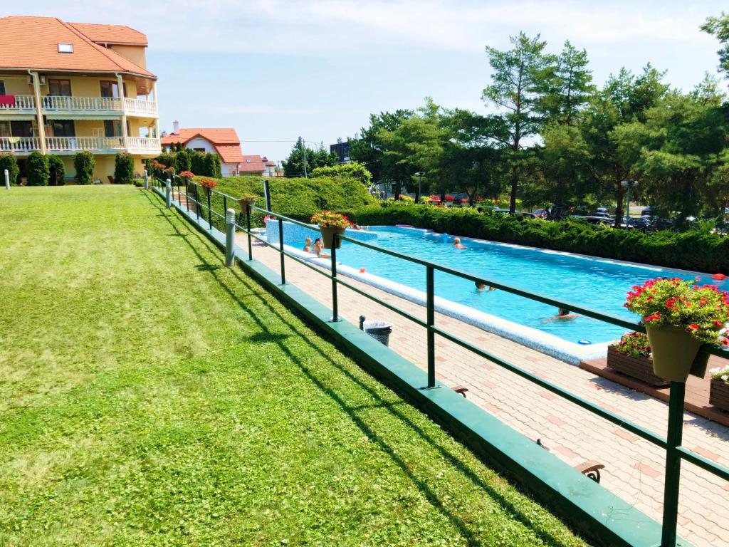 a swimming pool at a house with a yard at Fured Apartments II. in Balatonfüred