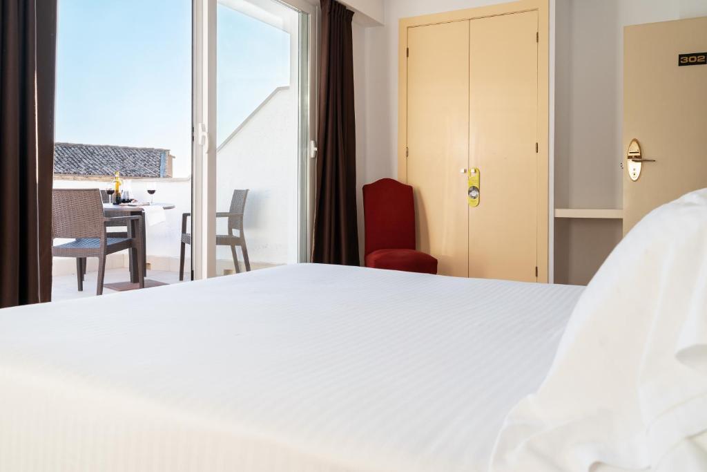Łóżko lub łóżka w pokoju w obiekcie Hotel Ciudad de Cazorla