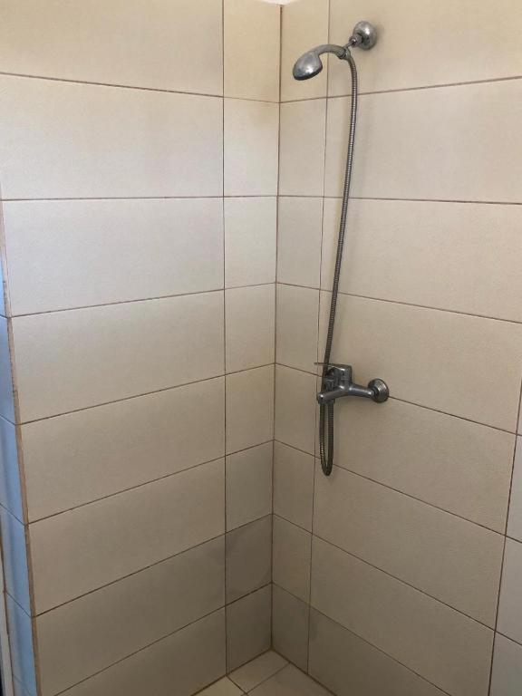 a shower in a bathroom with a glass door at Kedros Rooms in Prasonisi