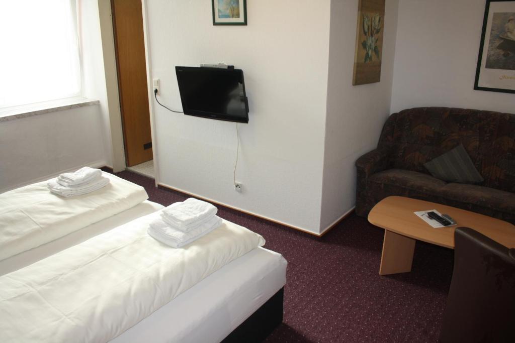 Postel nebo postele na pokoji v ubytování Hotel Am Kamin