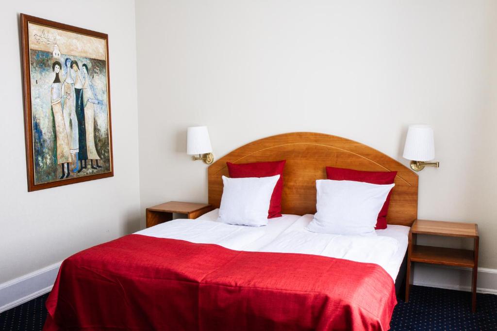 Postel nebo postele na pokoji v ubytování City Hotel Nebo