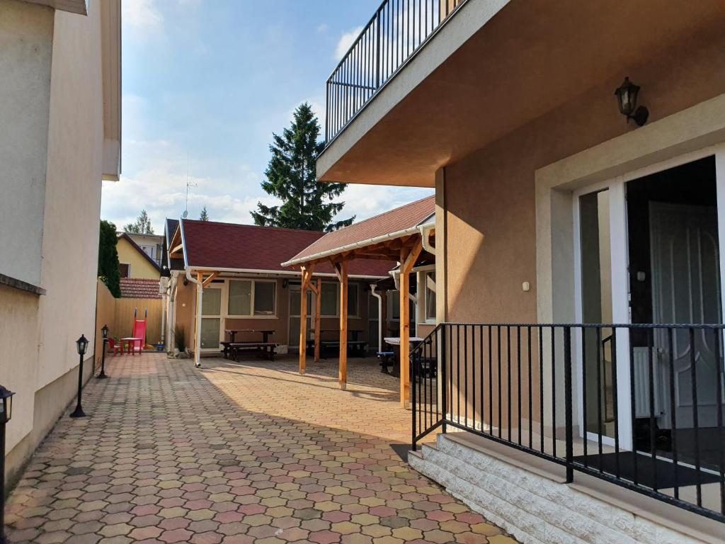 a building with a walkway in front of it at Party Vendégház in Hajdúszoboszló