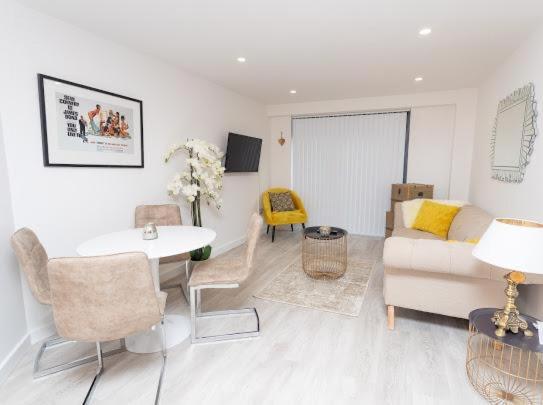 a living room with a couch and a table at Valdeni Apartments in Leeds