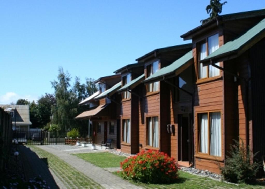 a wooden house with a pathway in front of it at Apart Hotel Villa Los Ciruelos in Valdivia