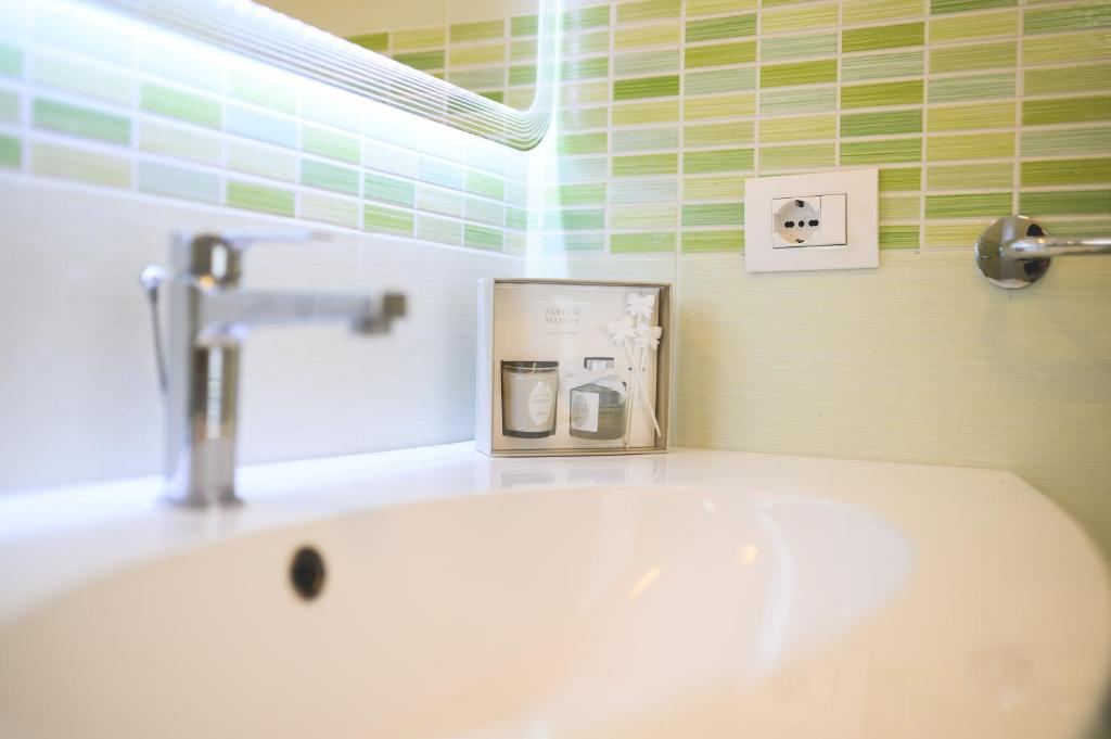 a bathroom sink with a soap dispenser on top of it at Parco Augusto in Capri