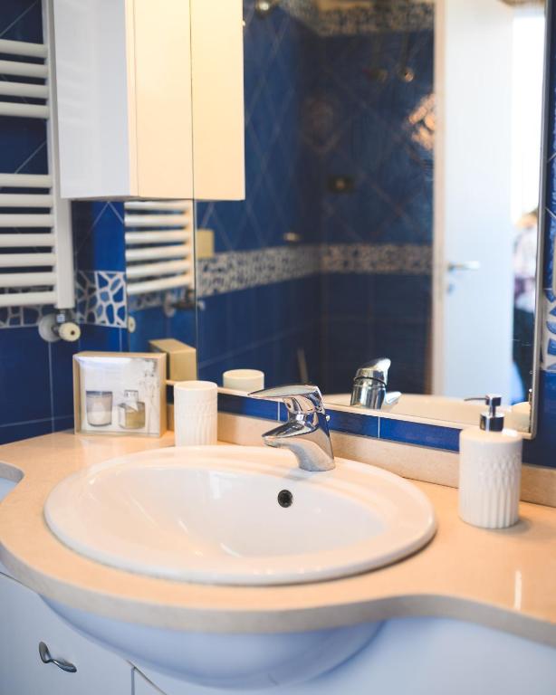 a bathroom with a white sink and a mirror at Parco Augusto in Capri
