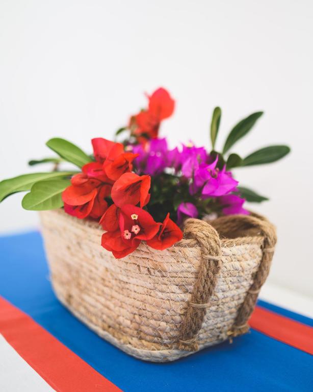a basket of flowers sitting on a table at Parco Augusto in Capri