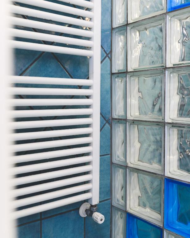 a glass block wall with a window in a bathroom at Parco Augusto in Capri